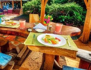 a wooden table with a plate of fruit on it at Alojamiento Sumak Kawsay in Puerto Ayora