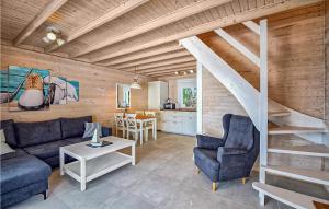 a living room with a blue couch and a staircase at Nice Home In Kolczewo With Wifi in Kołczewo