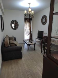 a living room with a couch and a table at Sweet Home Lina in Paralia Katerinis