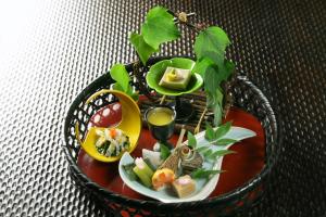 a bowl of food on a table with a plate of food at Hakone Onsen Ryokan Yaeikan in Hakone