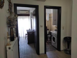 a bathroom with a sink and a washing machine at Sweet Home Lina in Paralia Katerinis +39 photos