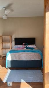 a bedroom with a bed with a blue comforter at Casa em São Francisco Xavier sp in São Francisco Xavier