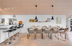 a dining room with a table and chairs at 4 Bedroom Cozy Home In Hadsund in Hadsund