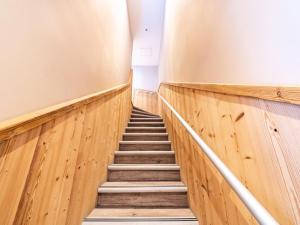 a staircase in a building with wooden walls and wooden floors at Chalet Millonex - Duplex rénové·skis aux pieds·WIFI·Cheminée MAE-4964 in Tignes
