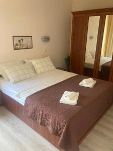 a bedroom with a bed with two towels on it at Milushevi apartment in Golden Sands +13 photos