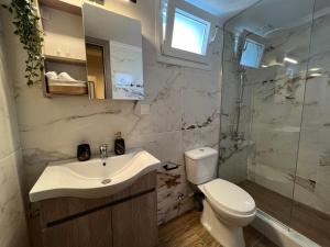 a bathroom with a sink and a toilet and a shower at Oasis Apartment 2 by GG in Alexandroupoli +29 photos