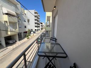 a balcony of a building with a bench on it at Oasis Apartment 2 by GG in Alexandroupoli