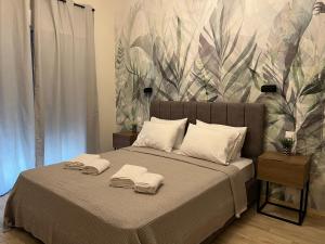 a bedroom with a bed with towels on it at Oasis Apartment 2 by GG in Alexandroupoli