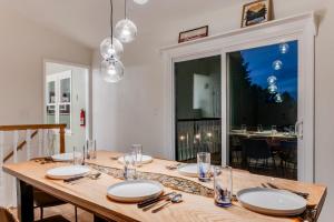 a wooden table with plates and napkins on it at The Getaway Lodge in the Blue Ridge Mountains near Roanoke & Bedford in Troutville