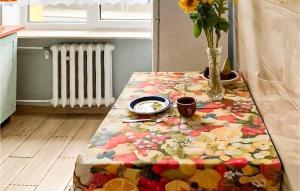 a table with a flowered table cloth on it at Beautiful Apartment In Zielona Góra in Zielona Góra