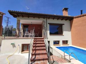 a villa with a swimming pool and a house at Casa La Peguera in La Parra