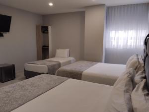 Uma cama ou camas num quarto em Hotel OR Suite