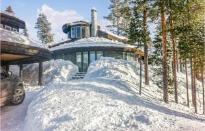 a house with a pile of snow in front of it at Lovely Home In Hemsedal With Sauna in Hemsedal