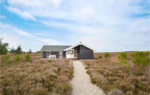 a small house in the middle of a field at Holiday Home Godthåbsvej Rømø Vi in Bolilmark