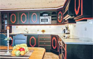 a kitchen with a table with a bowl of fruit on it at Skarsnuten in Hemsedal