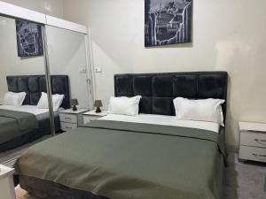 a bedroom with a large bed and a large mirror at F2 tout confort au Point E Dakar ! in Dakar