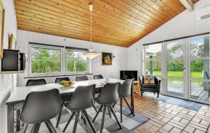 a dining room with a table and chairs at Holiday Home Sigfred Jensens Vej Hvide Sande Xi in Bjerregård