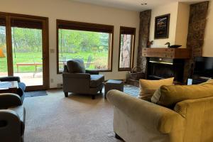 a living room with a couch and chairs and a fireplace at St John C in Jackson