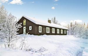 a barn covered in snow with snow covered trees at Holiday Home Gålå Peer Gyntlia Iv in Gålå +10 photos