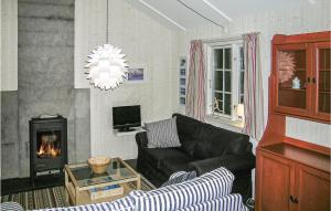 a living room with a couch and a fireplace at Holiday Home Gålå Peer Gyntlia Iv in Gålå