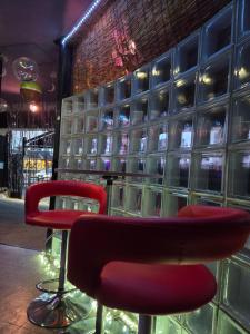 a bar with a red chair and a wall of wine glasses at X Hotel - Adult Only- in Sayama