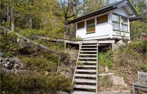 a tiny house on the side of a hill with stairs at Three-Bedroom Holiday Home In Tvedestrand in Tvedestrand