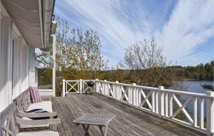 a deck with two chairs and a bench on a house at Three-Bedroom Holiday Home In Tvedestrand in Tvedestrand