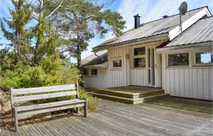 a house with a bench on a wooden deck at Three-Bedroom Holiday Home In Tvedestrand in Tvedestrand +13 photos