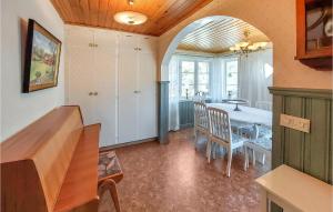 a kitchen and dining room with a table and chairs at Nice Home In Markaryd With Wifi in Markaryd