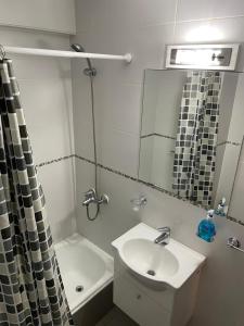 a white bathroom with a sink and a mirror at Mendoza Centro in Mendoza +29 photos
