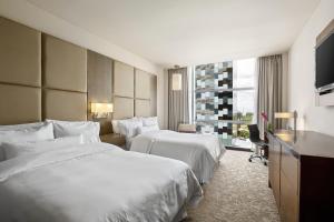 a hotel room with two beds and a window at The Westin Panama in Panama City