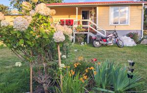 a motorcycle parked in front of a house at 2 Bedroom Cozy Home In Ramdala in Möcklö