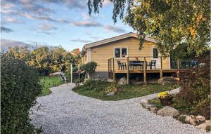 a small house with a porch and a patio at 2 Bedroom Cozy Home In Ramdala in Möcklö