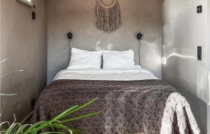 a bedroom with a bed with a blanket on it at Cozy Home In Vallda With Kitchen in Vallda