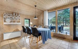 una sala da pranzo con tavolo e sedie di Three-Bedroom Holiday Home In Romo a Mølby Altre 12 foto