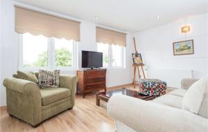 a living room with two chairs and a tv at 2 Bedroom Lovely Apartment In Darlowo in Darłowo