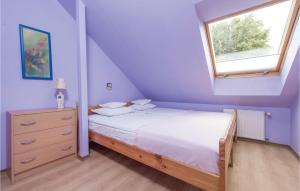 a small bedroom with a bed and a window at 2 Bedroom Lovely Apartment In Darlowo in Darłowo