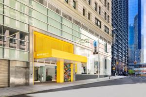 a building with a yellow canopy on a city street at Residence Inn by Marriott New York Downtown Manhattan/World Trade Center Area in New York