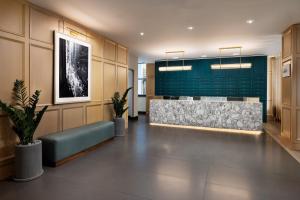 a lobby with a reception desk and a green wall at Residence Inn by Marriott New York Downtown Manhattan/World Trade Center Area in New York +35 photos