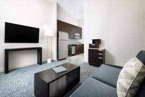 a living room with a couch and a tv at Residence Inn by Marriott New York Downtown Manhattan/World Trade Center Area in New York