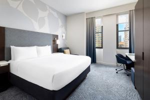 a hotel room with a large white bed and a desk at Residence Inn by Marriott New York Downtown Manhattan/World Trade Center Area in New York