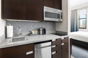 a kitchen with a sink and a microwave at Residence Inn by Marriott New York Downtown Manhattan/World Trade Center Area in New York