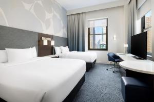 a hotel room with two beds and a desk at Residence Inn by Marriott New York Downtown Manhattan/World Trade Center Area in New York