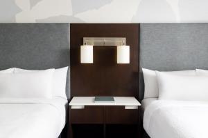 a hotel room with two beds and a table between them at Residence Inn by Marriott New York Downtown Manhattan/World Trade Center Area in New York