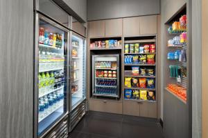 a grocery store aisle with refrigerators and drinks at Residence Inn by Marriott New York Downtown Manhattan/World Trade Center Area in New York