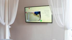 TV a/nebo společenská místnost v ubytování Giardini Malaspina