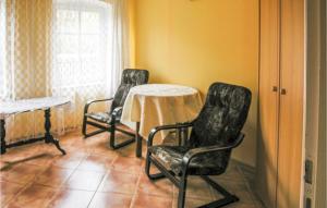 a room with two chairs and a table and a window at Holiday Home Cekcyn Ul Lesna in Cekcyn