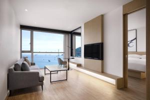 a living room with a couch and a bed at Fairfield by Marriott Busan Songdo Beach in Busan