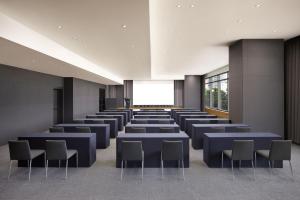 a large room with blue tables and chairs at Fairfield by Marriott Busan Songdo Beach in Busan