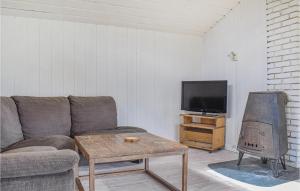 a living room with a couch and a tv at 2 Bedroom Cozy Home In Vallavik in Bu